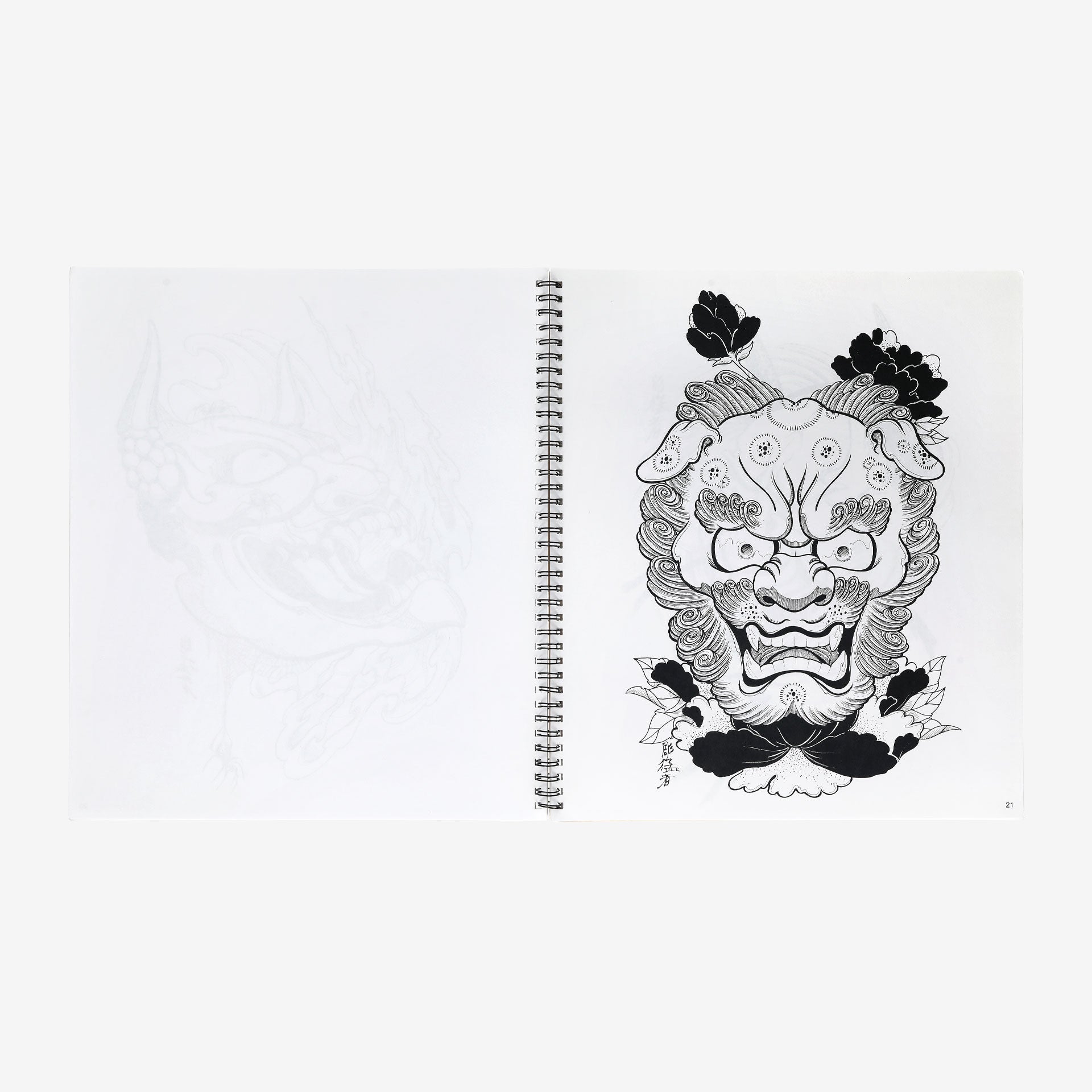 Notebook with a black and white illustration of a mask on a white background