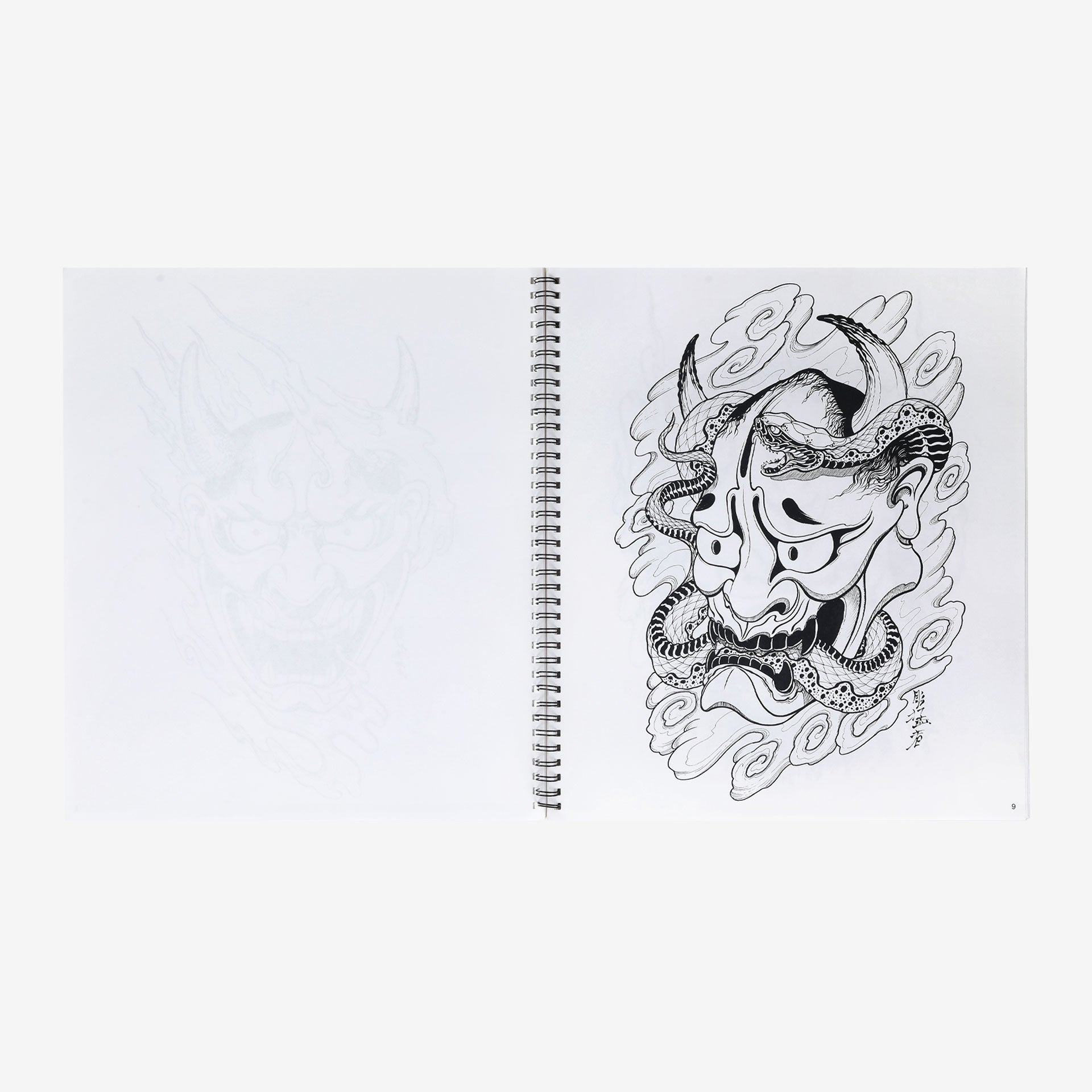 Notebook with a black and white illustration of a mask on a white background